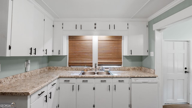 kitchen featuring white dishwasher, light countertops, white cabinets, and a sink