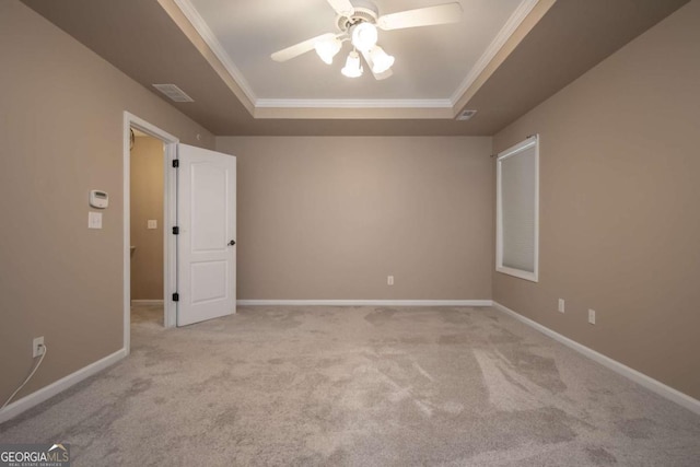 96 Portico Pl, Newnan, GA 30265 - carpeted empty room with ornamental molding, visible vents, a ceiling fan, a tray ceiling, and baseboards