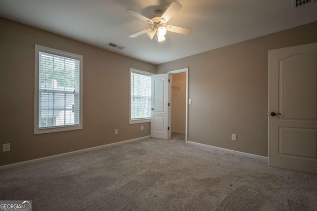 96 Portico Pl, Newnan, GA 30265 - unfurnished bedroom with carpet flooring, baseboards, visible vents, and multiple windows