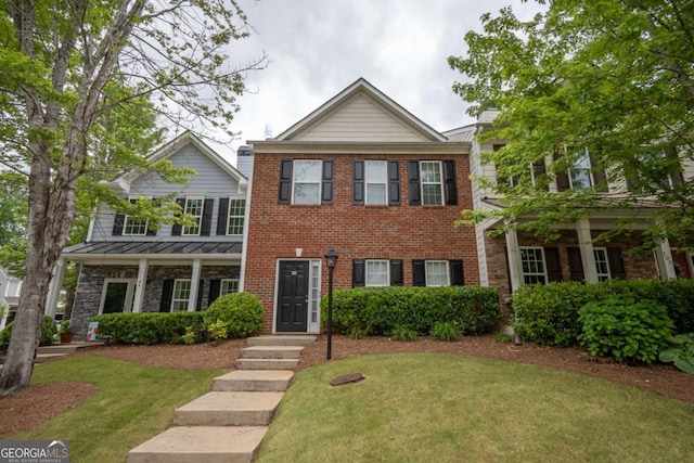 96 Portico Pl, Newnan, GA 30265 - view of front of home featuring brick siding, a front yard, and a standing seam roof