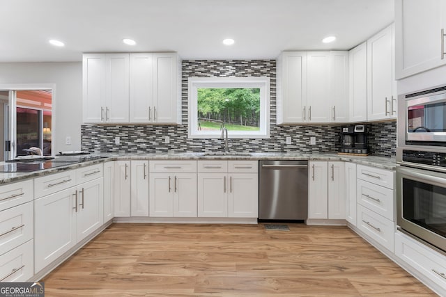 5830 Wilbanks Dr, Peachtree Corners, GA 30092 - kitchen featuring appliances with stainless steel finishes, a sink, white cabinetry, backsplash, and recessed lighting