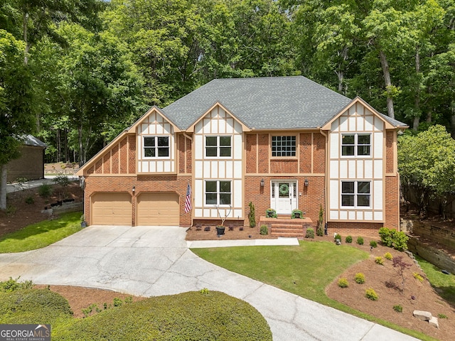 5830 Wilbanks Dr, Peachtree Corners, GA 30092 - tudor home featuring driveway, brick siding, a front yard, a garage, and roof with shingles