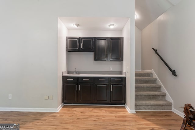 5830 Wilbanks Dr, Peachtree Corners, GA 30092 - indoor wet bar with light wood-style floors, baseboards, and vaulted ceiling