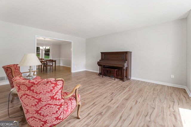 5830 Wilbanks Dr, Peachtree Corners, GA 30092 - sitting room featuring a chandelier, wood finished floors, and baseboards