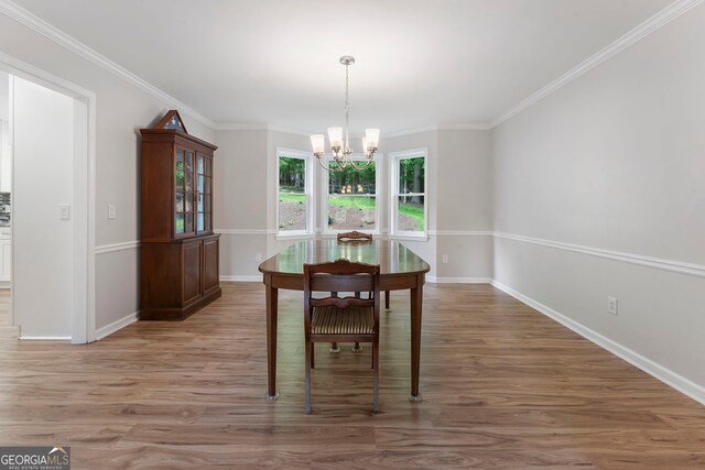 5830 Wilbanks Dr, Peachtree Corners, GA 30092 - dining area with a chandelier, light wood-style flooring, baseboards, and ornamental molding