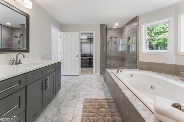5830 Wilbanks Dr, Peachtree Corners, GA 30092 - bathroom featuring marble look tiles, a shower stall, a walk in closet, vanity, and recessed lighting