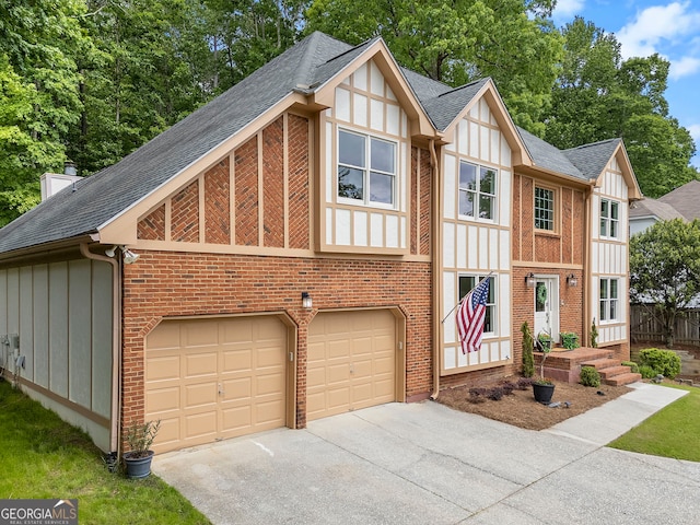 5830 Wilbanks Dr, Peachtree Corners, GA 30092 - tudor home with driveway, roof with shingles, and board and batten siding