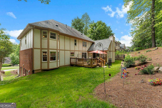 5830 Wilbanks Dr, Peachtree Corners, GA 30092 - back of property with a deck, a lawn, board and batten siding, brick siding, and a chimney