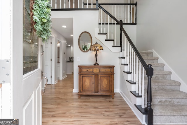 5830 Wilbanks Dr, Peachtree Corners, GA 30092 - stairway with wood finished floors, baseboards, and a towering ceiling