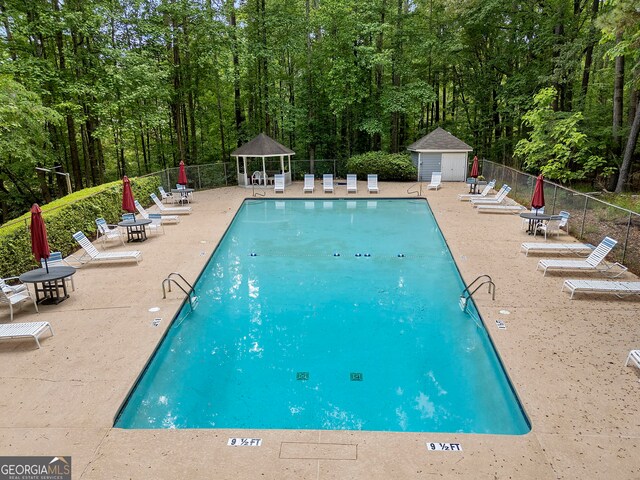 5830 Wilbanks Dr, Peachtree Corners, GA 30092 - community pool featuring fence, a patio, a gazebo, and a wooded view