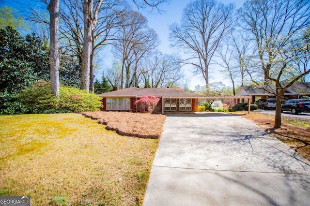 1181 Angelia Dr SW, Mableton, GA 30126 - ranch-style house featuring a carport, a front lawn, a chimney, and driveway