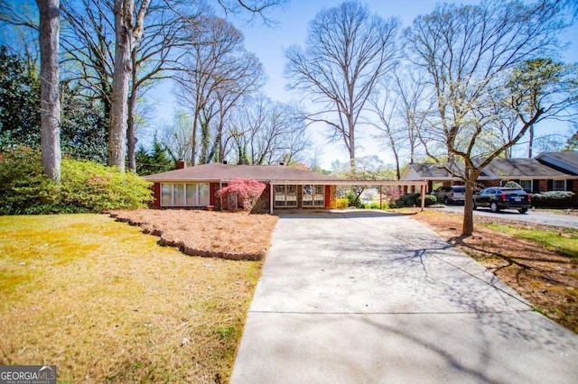1181 Angelia Dr SW, Mableton, GA 30126 - single story home featuring french doors, driveway, a front yard, an attached carport, and a chimney