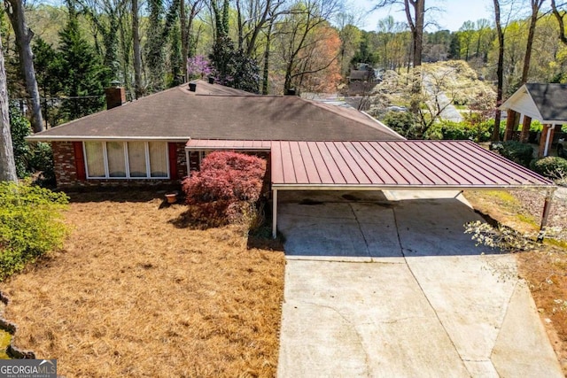 1181 Angelia Dr SW, Mableton, GA 30126 - view of front of home with a chimney, a standing seam roof, metal roof, concrete driveway, and a carport