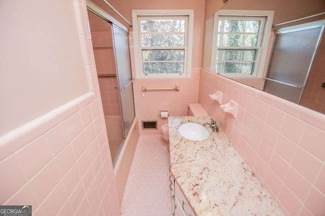 1181 Angelia Dr SW, Mableton, GA 30126 - full bathroom featuring tile walls, visible vents, tile patterned floors, vanity, and an enclosed shower