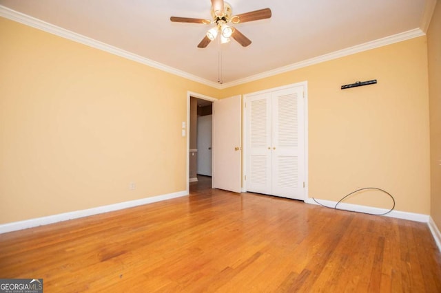 1181 Angelia Dr SW, Mableton, GA 30126 - unfurnished bedroom featuring baseboards, a closet, crown molding, and wood finished floors