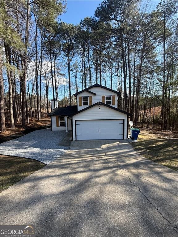 5075 Forest Downs Ln, Atlanta, GA 30349 - split level home with driveway and a garage