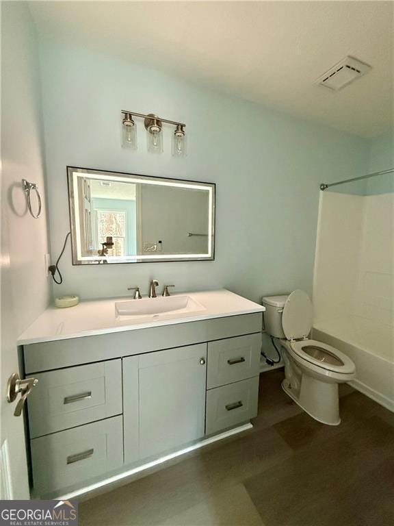 5075 Forest Downs Ln, Atlanta, GA 30349 - full bathroom featuring toilet, vanity, visible vents, and shower / bathing tub combination