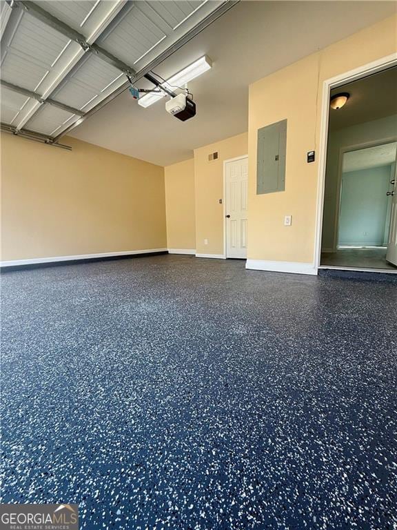 5075 Forest Downs Ln, Atlanta, GA 30349 - garage featuring electric panel, baseboards, and a garage door opener