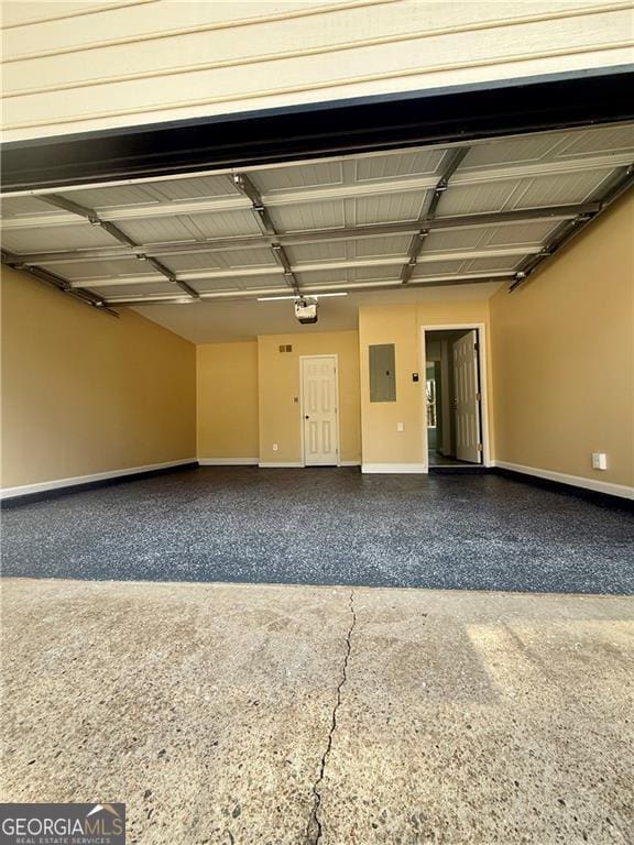 5075 Forest Downs Ln, Atlanta, GA 30349 - garage with electric panel, baseboards, and a garage door opener