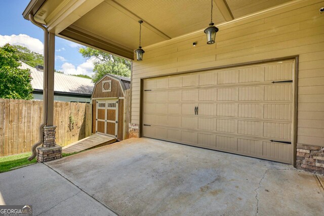 308 N Midland Ave, Monroe, GA 30655 - garage with fence, concrete driveway, and a shed