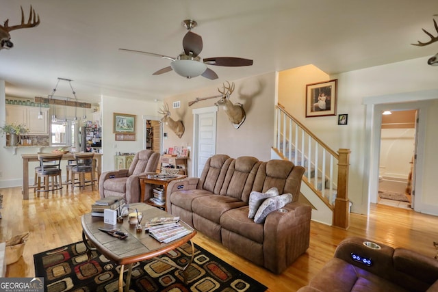 308 N Midland Ave, Monroe, GA 30655 - living area with stairway, light wood-style flooring, and a ceiling fan