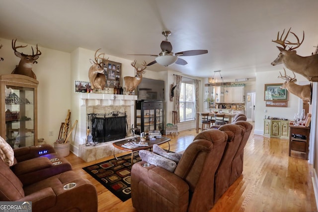 308 N Midland Ave, Monroe, GA 30655 - living area with a fireplace, light wood-type flooring, and a ceiling fan