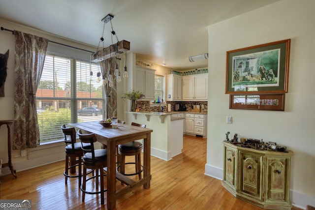 308 N Midland Ave, Monroe, GA 30655 - dining room with baseboards and light wood-type flooring