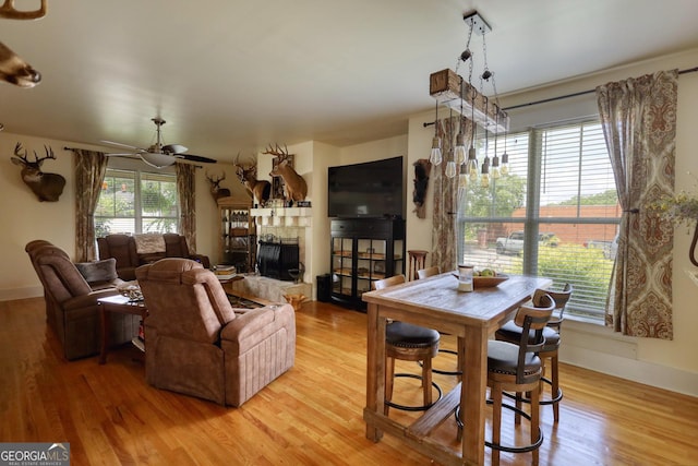 308 N Midland Ave, Monroe, GA 30655 - living room with baseboards, light wood-style floors, a fireplace, and ceiling fan