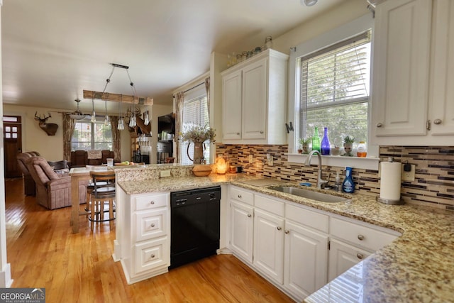 308 N Midland Ave, Monroe, GA 30655 - kitchen featuring a sink, tasteful backsplash, dishwasher, light wood finished floors, and white cabinets