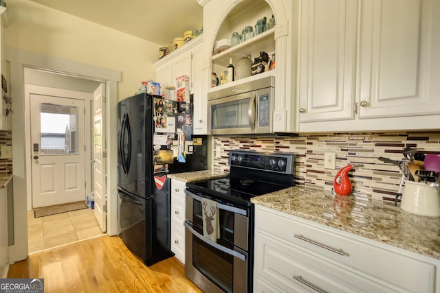 308 N Midland Ave, Monroe, GA 30655 - kitchen featuring decorative backsplash, stainless steel appliances, light stone counters, and white cabinetry