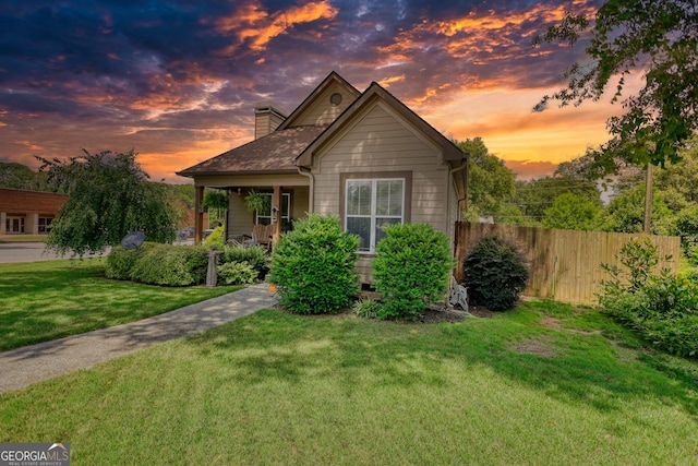 308 N Midland Ave, Monroe, GA 30655 - bungalow with a front lawn, a porch, a chimney, and fence