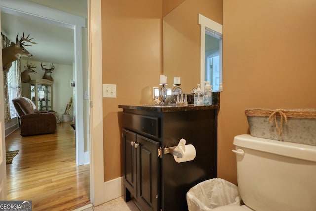 308 N Midland Ave, Monroe, GA 30655 - half bath featuring toilet, baseboards, vanity, and wood finished floors