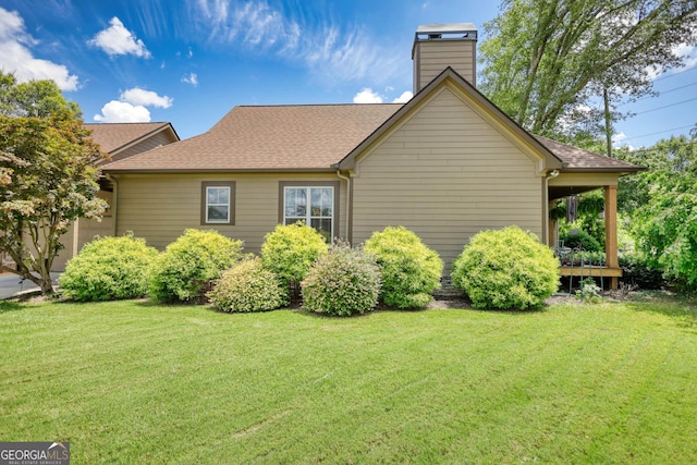 308 N Midland Ave, Monroe, GA 30655 - view of side of home featuring a yard, a chimney, and a shingled roof