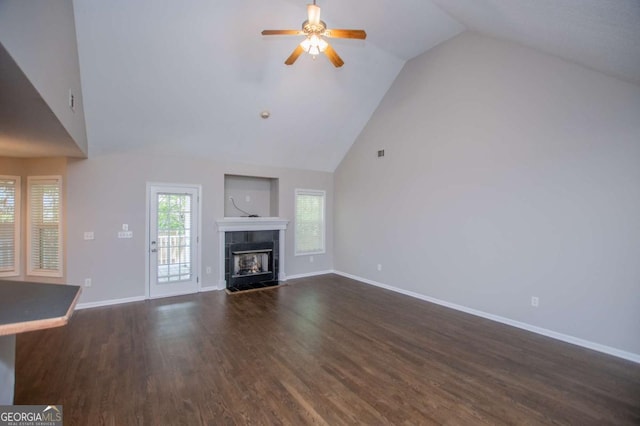 unfurnished living room featuring high vaulted ceiling, baseboards, ceiling fan, and dark wood-style floors