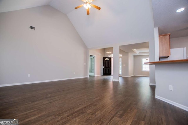 unfurnished living room featuring high vaulted ceiling, visible vents, baseboards, ceiling fan, and dark wood-style floors