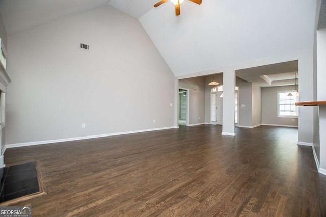 unfurnished living room with high vaulted ceiling, visible vents, dark wood-style flooring, a ceiling fan, and baseboards