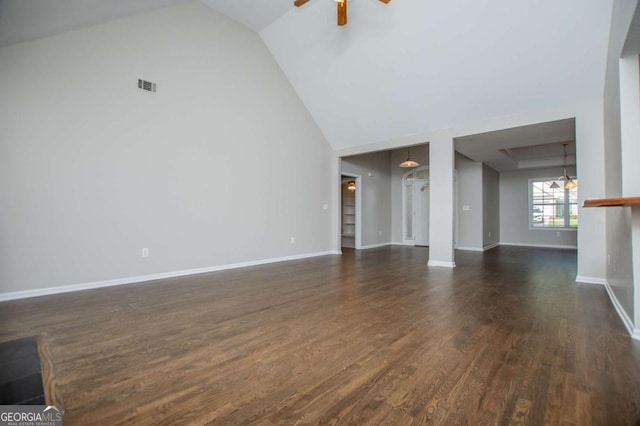 unfurnished living room with high vaulted ceiling, visible vents, dark wood-style flooring, ceiling fan, and baseboards