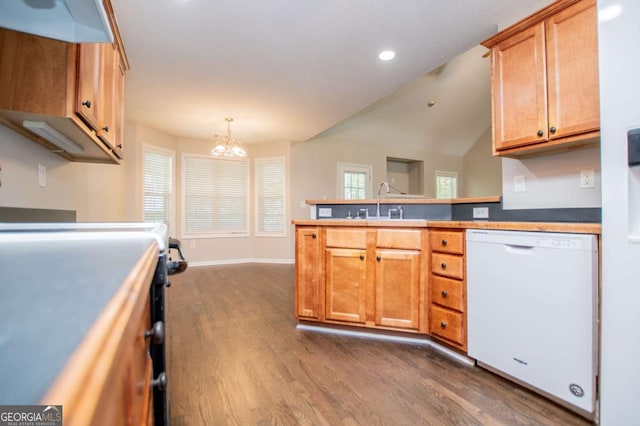 kitchen with dishwasher, a sink, a peninsula, a chandelier, and dark wood-type flooring