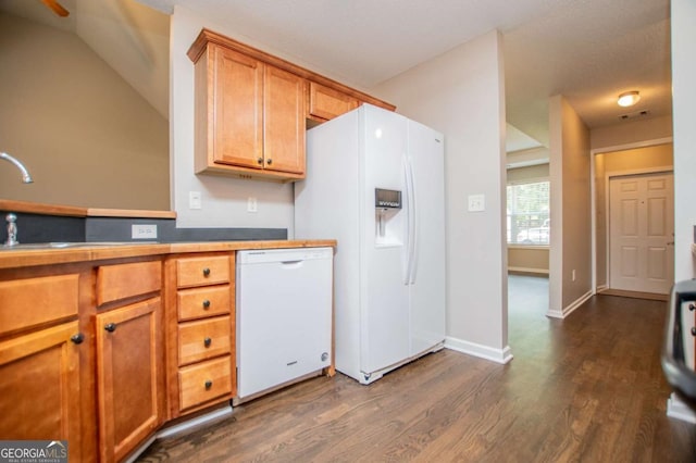 kitchen featuring dark wood-style flooring, white appliances, brown cabinets, and visible vents