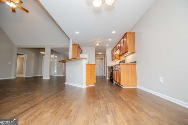 unfurnished living room featuring baseboards, a ceiling fan, and dark wood-type flooring