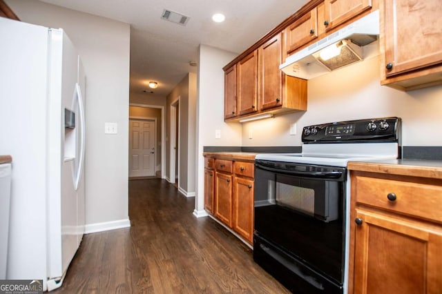kitchen featuring visible vents, under cabinet range hood, dark wood-style flooring, electric range, and white refrigerator with ice dispenser