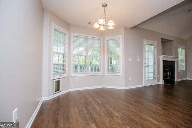 unfurnished living room with a fireplace, a chandelier, dark wood-style flooring, and baseboards