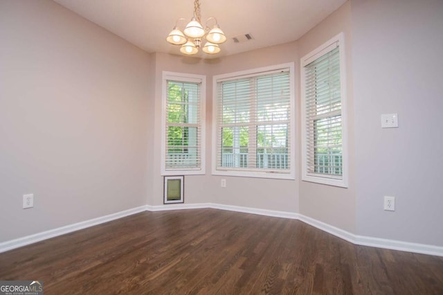 interior space featuring a notable chandelier, baseboards, visible vents, and dark wood finished floors