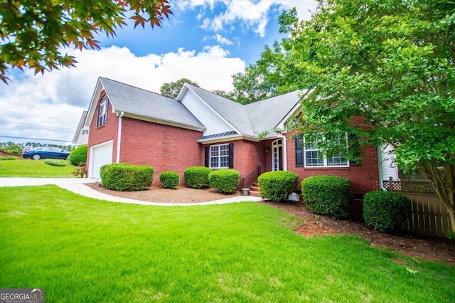 view of front of home featuring brick siding, fence, and a front yard