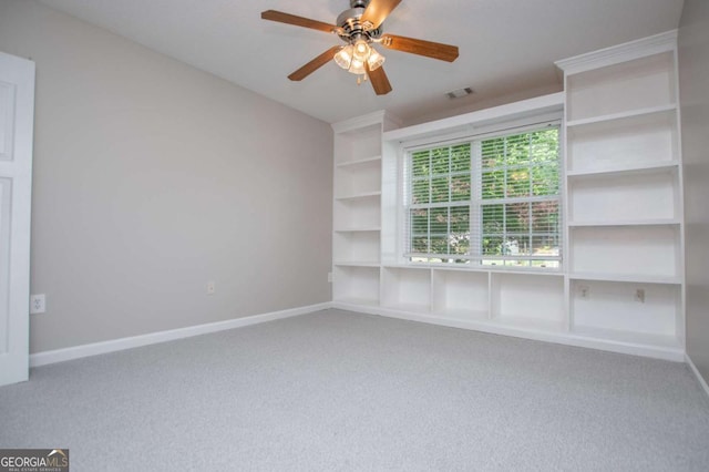 unfurnished room with baseboards, ceiling fan, visible vents, and carpet