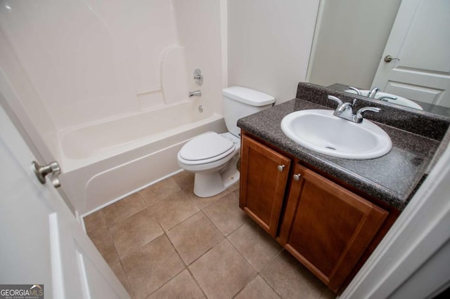 bathroom featuring toilet, tile patterned flooring, vanity, and washtub / shower combination
