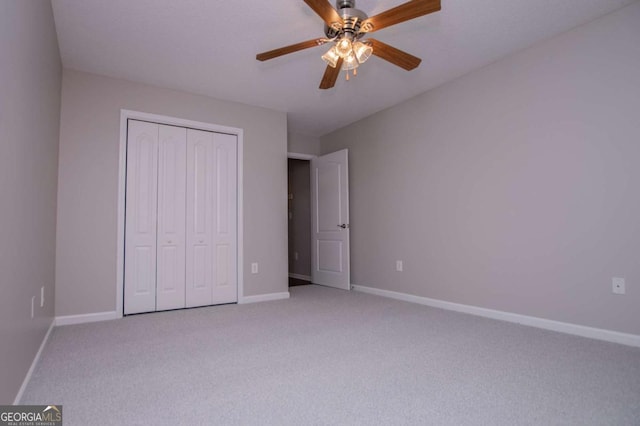unfurnished bedroom with light carpet, baseboards, and a closet