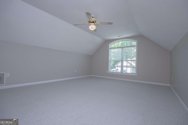 additional living space featuring vaulted ceiling, carpet, and baseboards