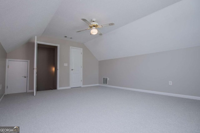 bonus room featuring lofted ceiling, carpet flooring, baseboards, and visible vents