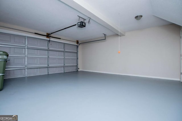 garage featuring baseboards and a garage door opener